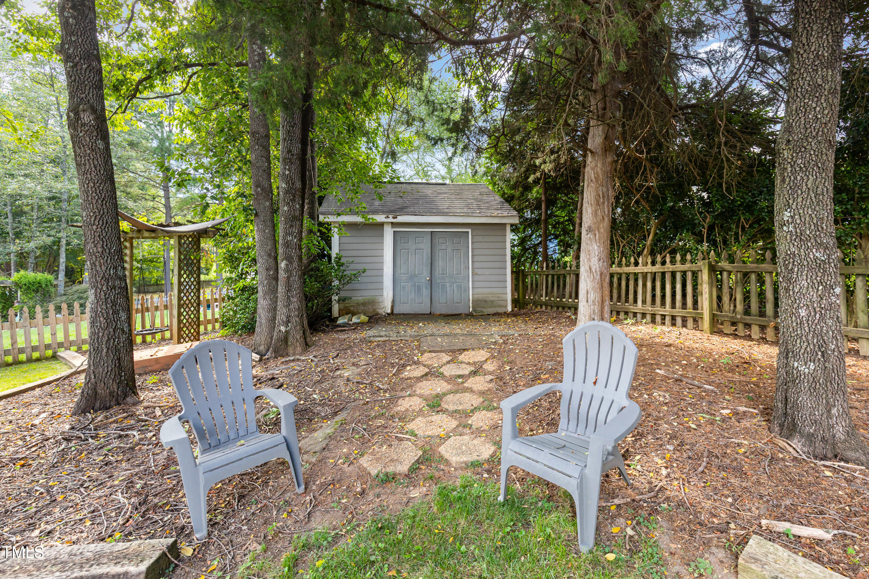 9316 Dawnshire Road Raleigh, NC 27615 - Photo 24 of 31 a view of a chair and table in backyard of the house