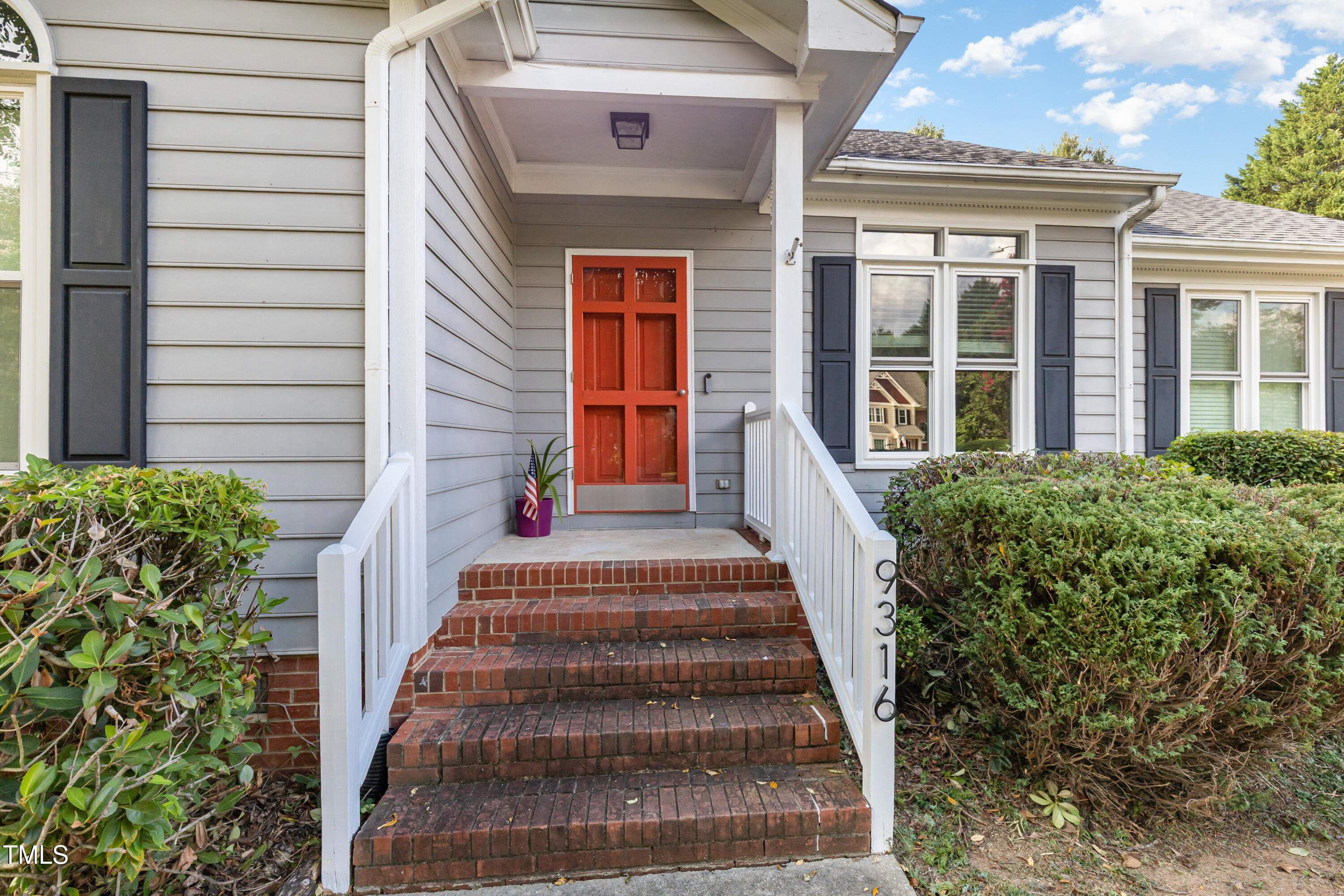 9316 Dawnshire Road Raleigh, NC 27615 - Photo 4 of 31 a view of a house with large windows and plants