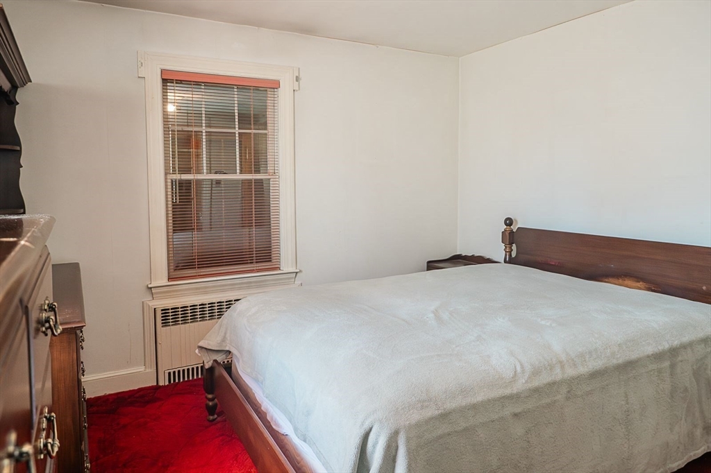 7 Park Street Hamilton, MA 01982 - Photo 11 of 36 a bedroom with a bed and a window