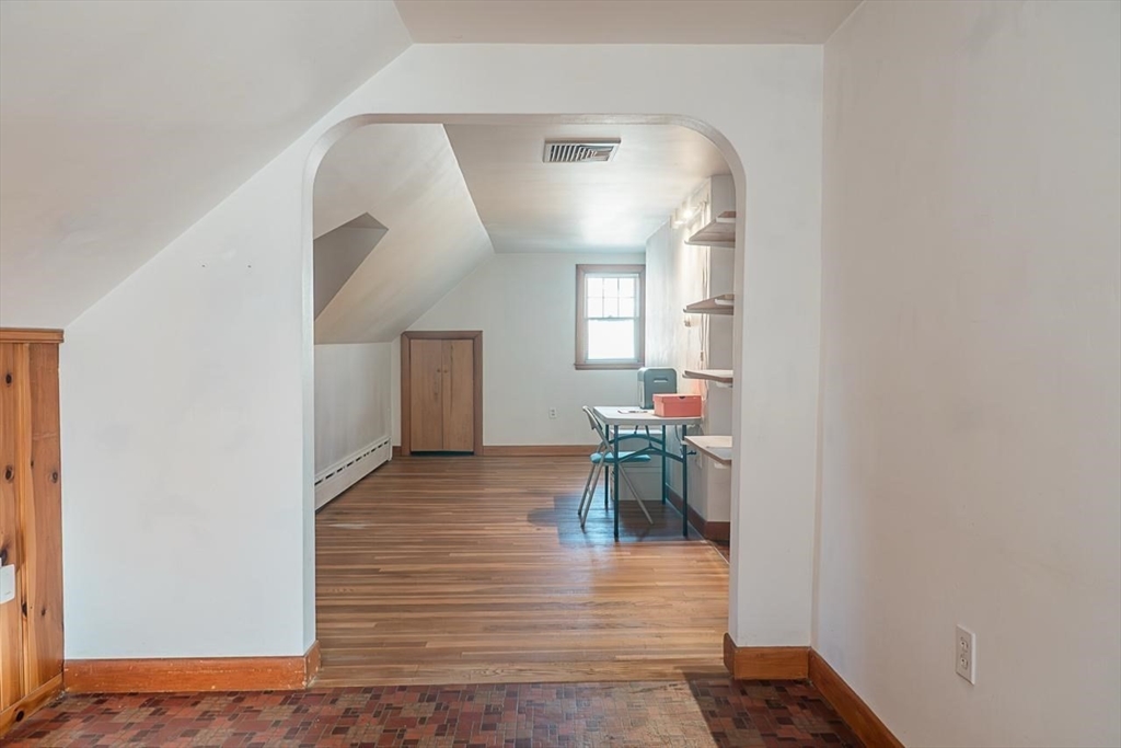 7 Park Street Hamilton, MA 01982 - Photo 13 of 36 a view of a hallway with wooden floor and a dining room