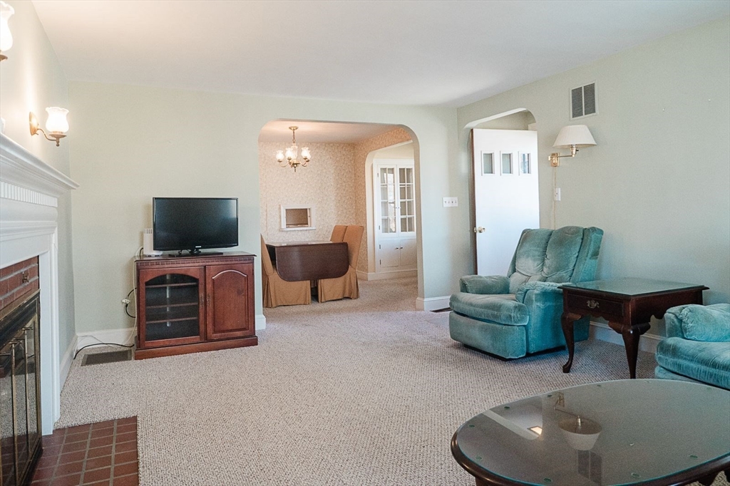 7 Park Street Hamilton, MA 01982 - Photo 2 of 36 a living room with furniture and a flat screen tv