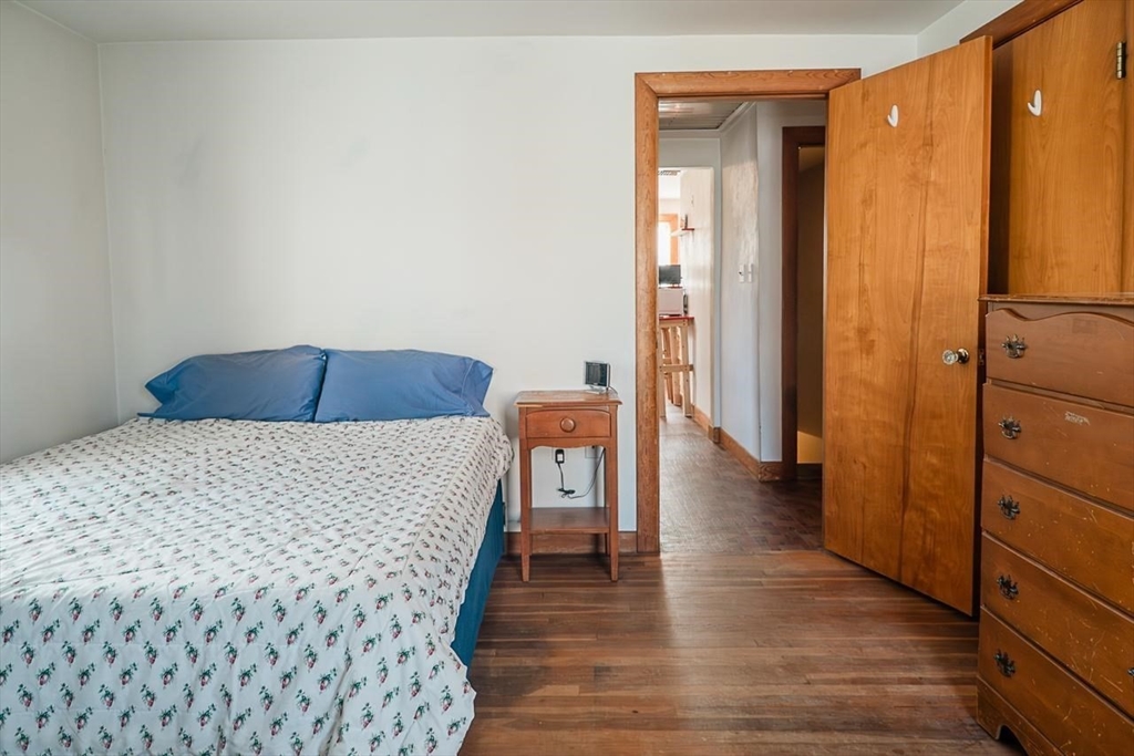 7 Park Street Hamilton, MA 01982 - Photo 24 of 36 a bedroom with a bed and wooden floor