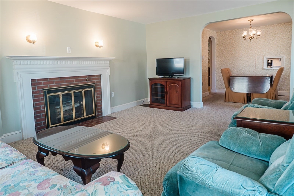 7 Park Street Hamilton, MA 01982 - Photo 4 of 36 a living room with furniture and a fireplace