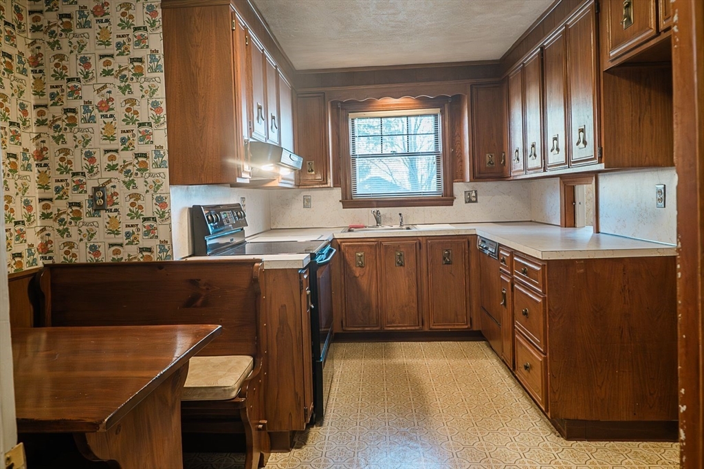 7 Park Street Hamilton, MA 01982 - Photo 6 of 36 a kitchen with stainless steel appliances granite countertop a sink stove and cabinets