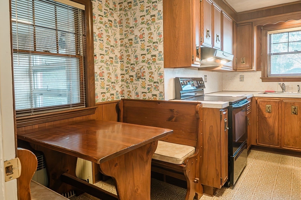 7 Park Street Hamilton, MA 01982 - Photo 9 of 36 a kitchen with a table chairs cabinets and window