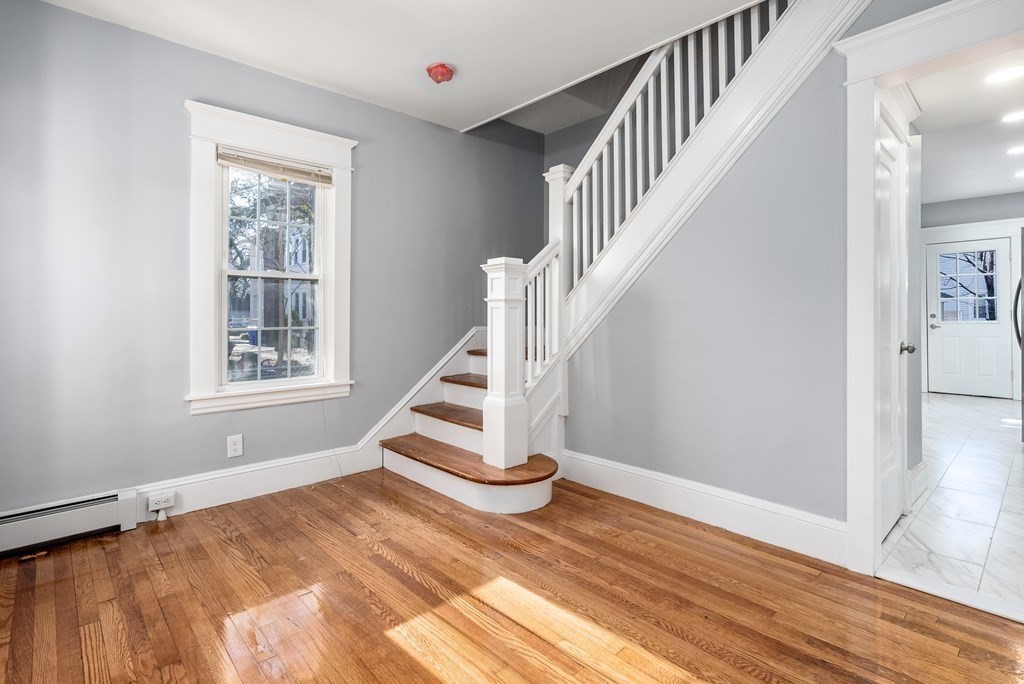 14 Burton Street Springfield, MA 01108 - Photo 11 of 35 a view of entryway with wooden floor and stairs