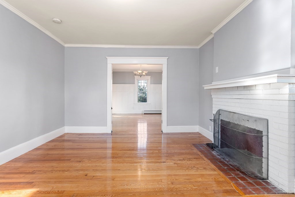 14 Burton Street Springfield, MA 01108 - Photo 12 of 35 a view of a livingroom with wooden floor and a fireplace