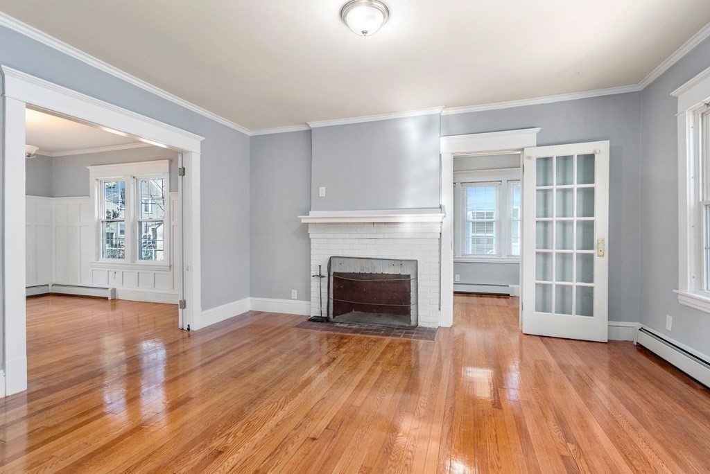 14 Burton Street Springfield, MA 01108 - Photo 13 of 35 an empty room with wooden floor fireplace and windows