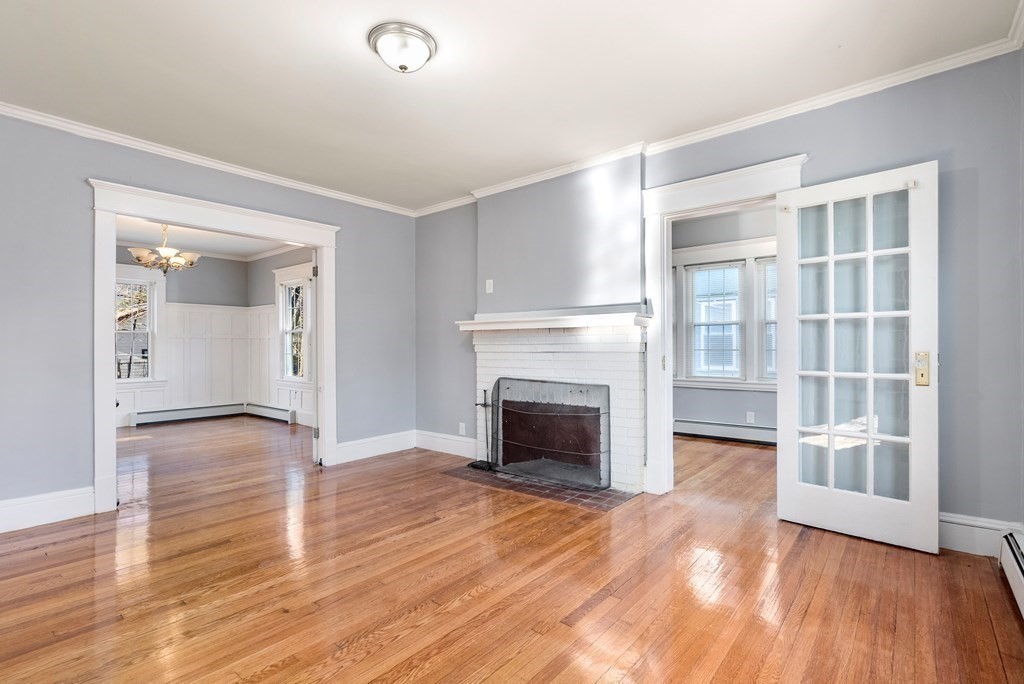 14 Burton Street Springfield, MA 01108 - Photo 14 of 35 wooden floor fireplace and windows in an empty room
