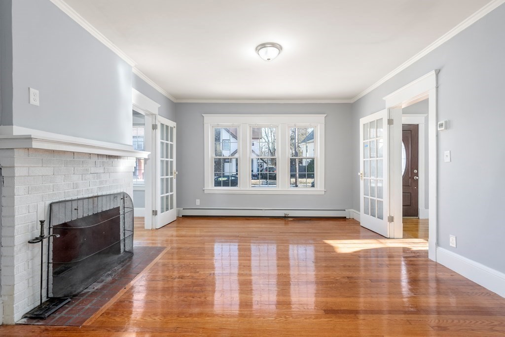 14 Burton Street Springfield, MA 01108 - Photo 15 of 35 a view of empty room with wooden floor and fireplace