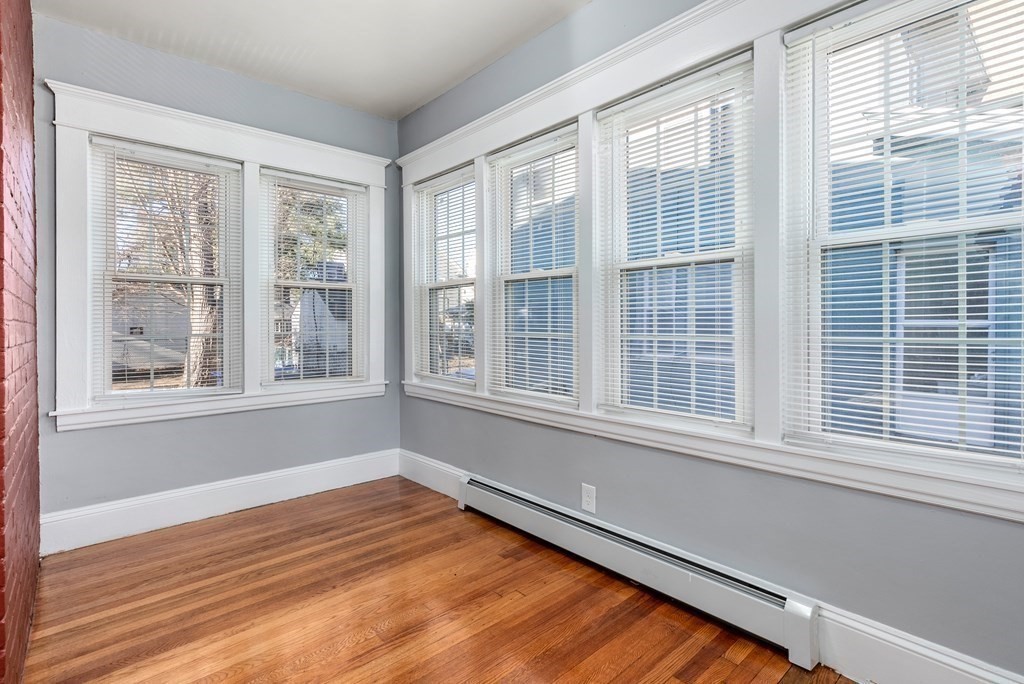 14 Burton Street Springfield, MA 01108 - Photo 18 of 35 a view of an empty room with wooden floor and a window