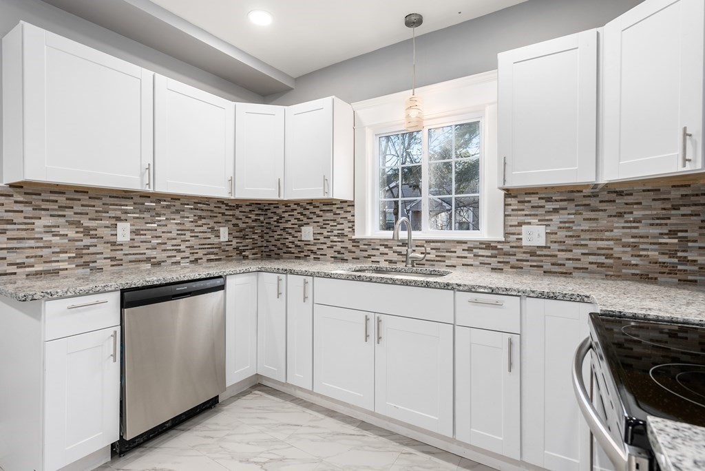 14 Burton Street Springfield, MA 01108 - Photo 22 of 35 a kitchen with granite countertop a sink stove and cabinets