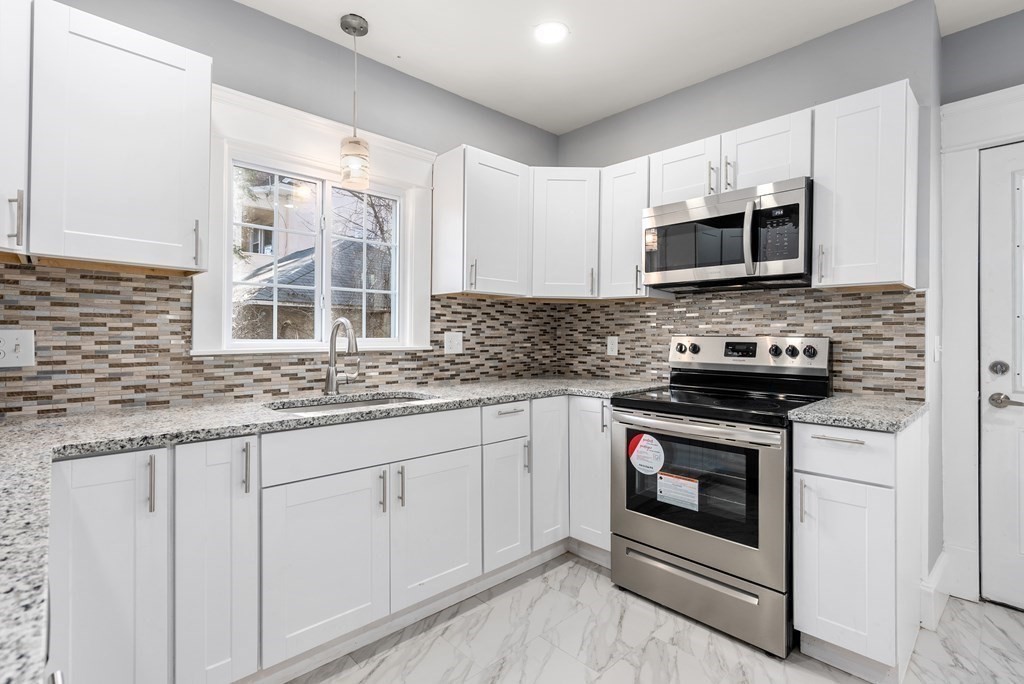 14 Burton Street Springfield, MA 01108 - Photo 23 of 35 a kitchen with stainless steel appliances granite countertop a stove sink microwave and cabinets