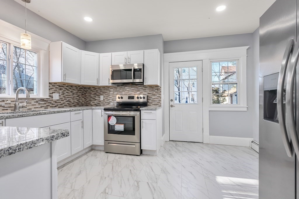14 Burton Street Springfield, MA 01108 - Photo 25 of 35 a kitchen with stainless steel appliances granite countertop a stove and a refrigerator