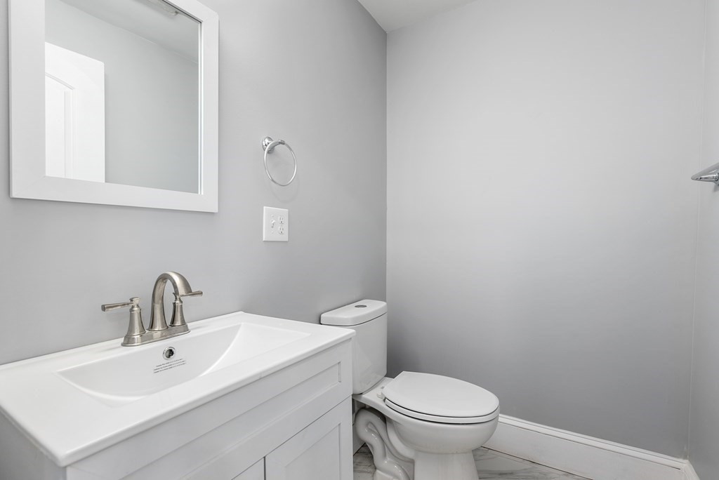 14 Burton Street Springfield, MA 01108 - Photo 26 of 35 a bathroom with a toilet a sink and mirror