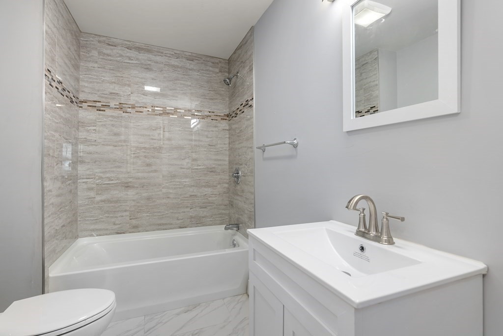 14 Burton Street Springfield, MA 01108 - Photo 27 of 35 a bathroom with a sink mirror toilet and bathtub