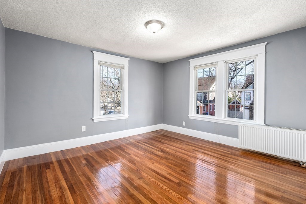 14 Burton Street Springfield, MA 01108 - Photo 28 of 35 a view of an empty room with wooden floor and a window