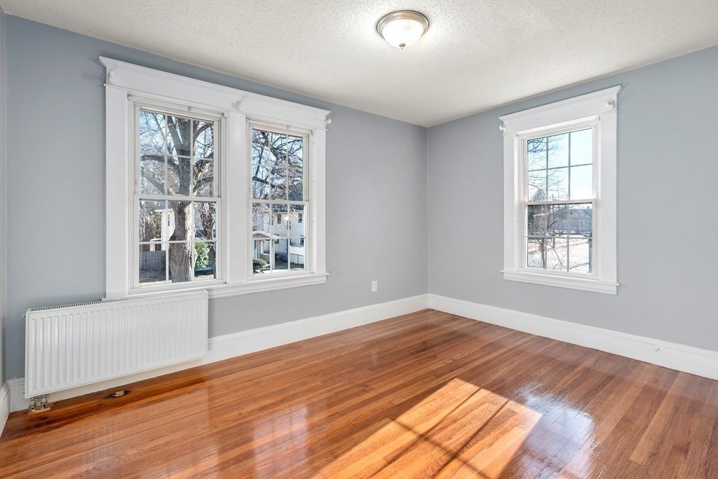 14 Burton Street Springfield, MA 01108 - Photo 29 of 35 a view of an empty room with wooden floor and a window