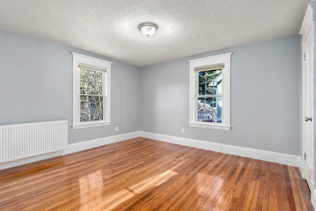 14 Burton Street Springfield, MA 01108 - Photo 31 of 35 a view of an empty room with wooden floor and a window