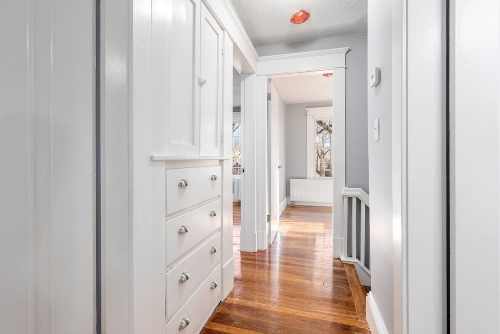 14 Burton Street Springfield, MA 01108 - Photo 32 of 35 a view of a hallway with wooden floor and closet