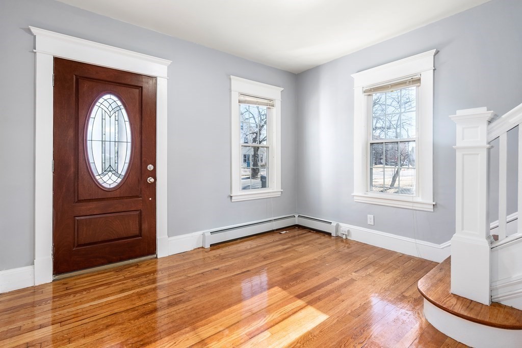 14 Burton Street Springfield, MA 01108 - Photo 10 of 35 a view of a livingroom with wooden floor and window