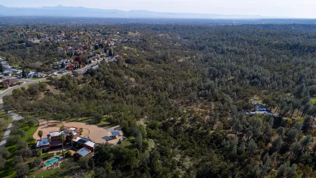 an aerial view of house with yard and mountain view