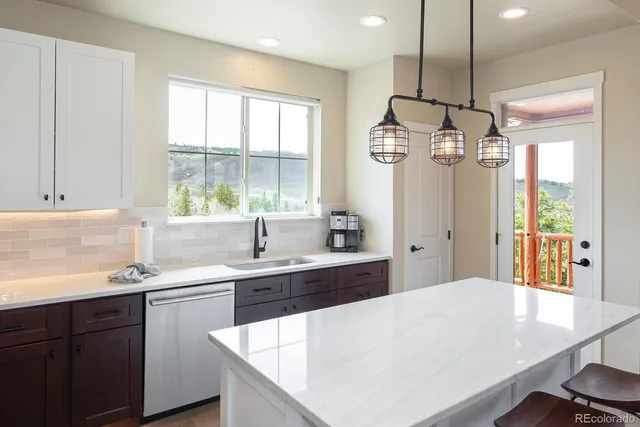 a kitchen with a sink a window and refrigerator