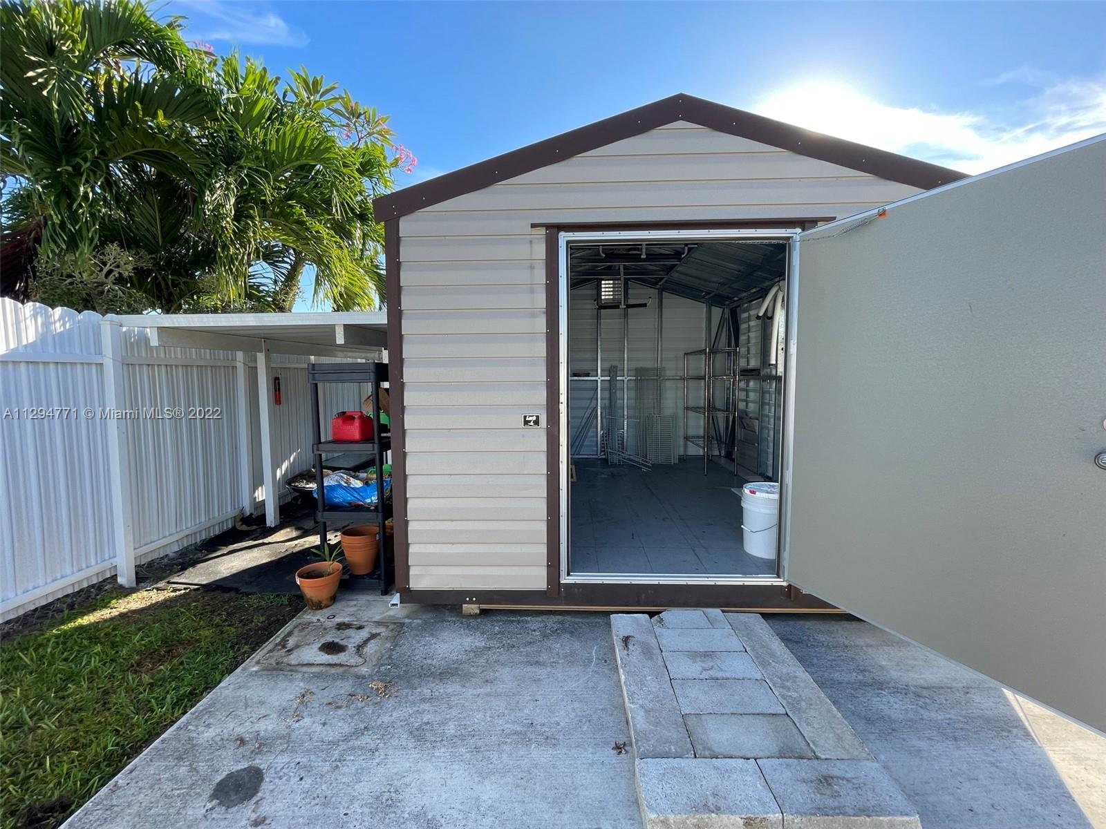 14515 Southwest 105th Court Miami, FL 33176 - Photo 22 of 30 a view of a garage of the house