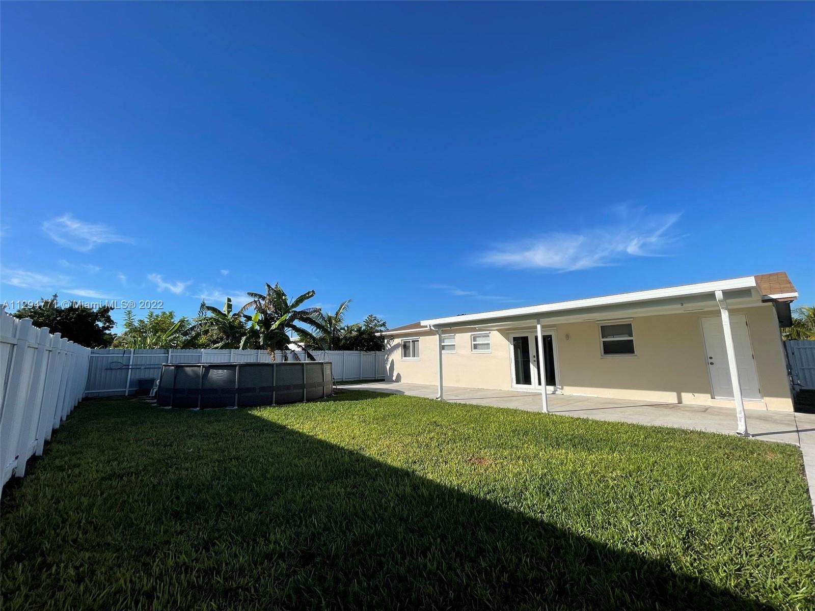14515 Southwest 105th Court Miami, FL 33176 - Photo 24 of 30 a view of an house with backyard space and garden