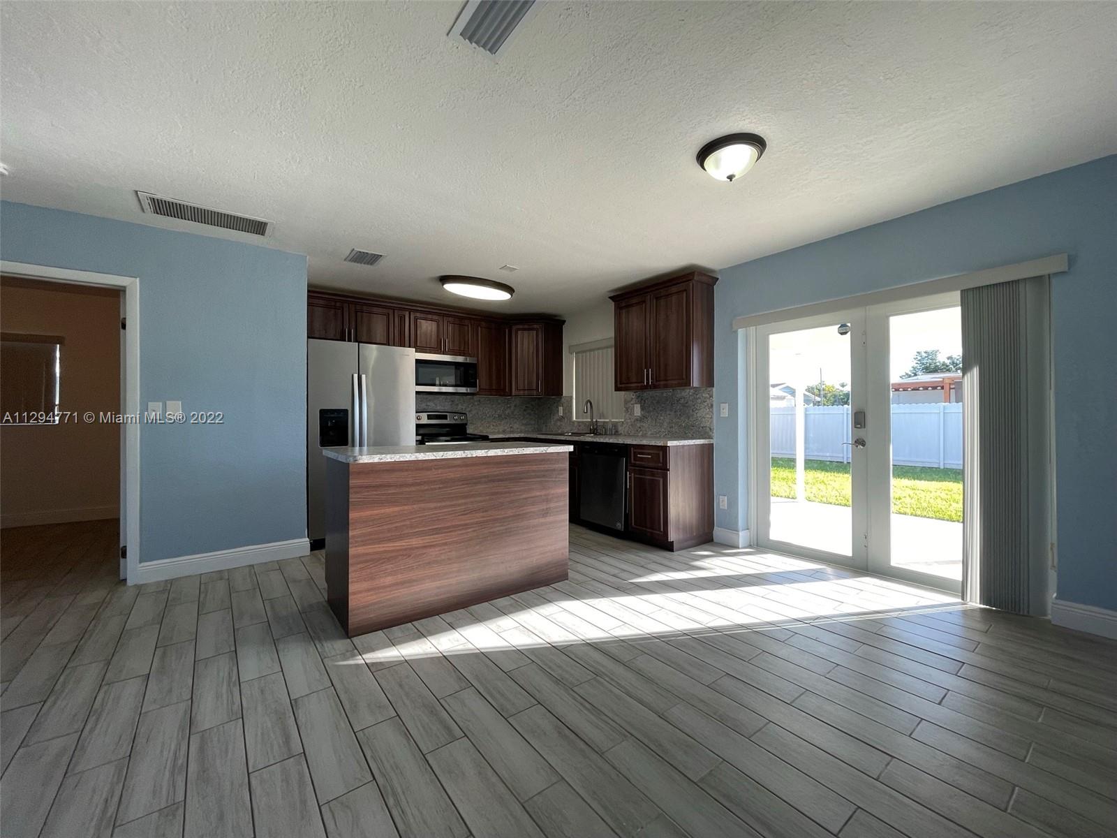 14515 Southwest 105th Court Miami, FL 33176 - Photo 5 of 30 a view of kitchen with wooden floor