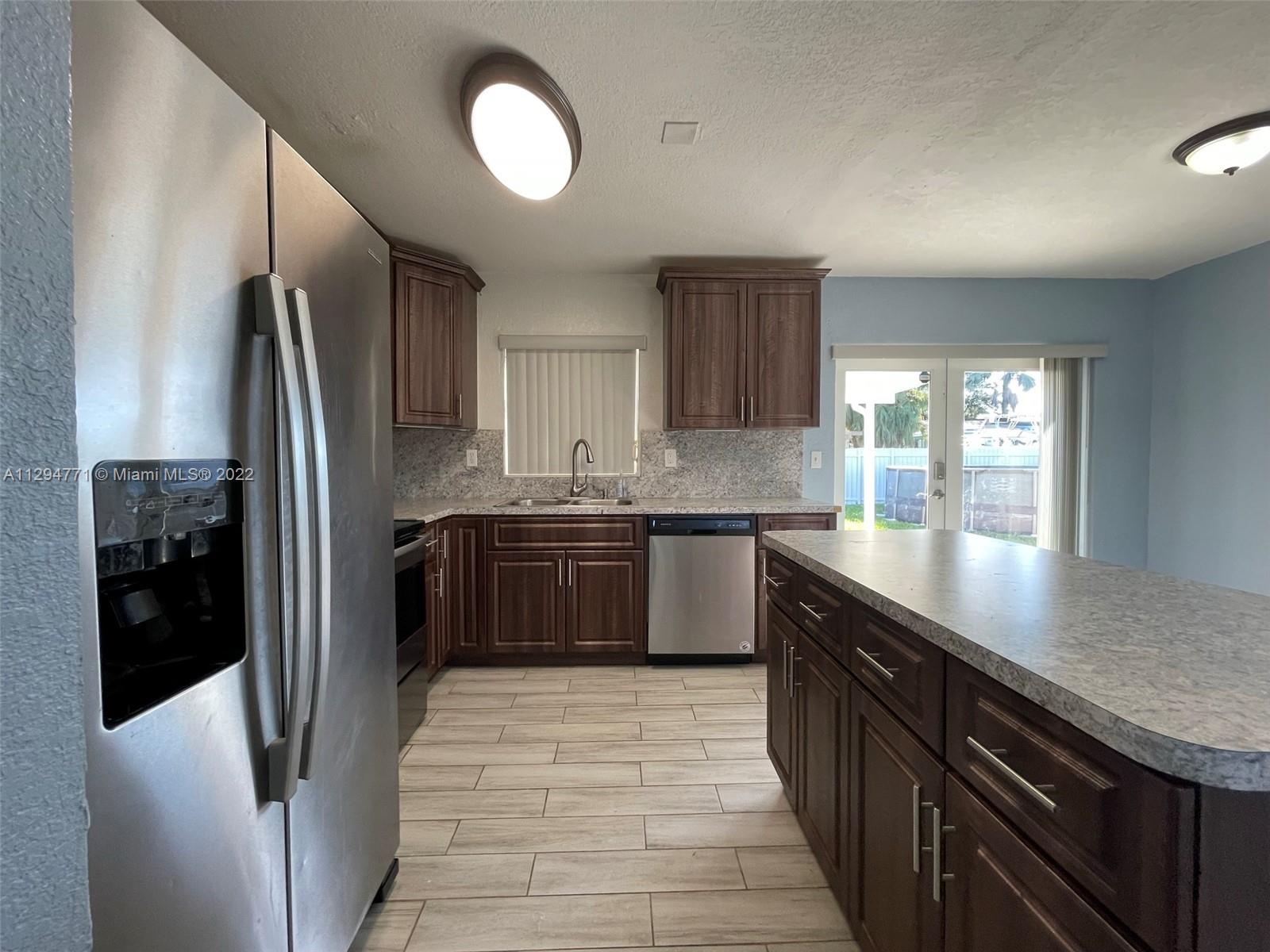 14515 Southwest 105th Court Miami, FL 33176 - Photo 8 of 30 a kitchen with stainless steel appliances granite countertop a refrigerator a sink and a stove