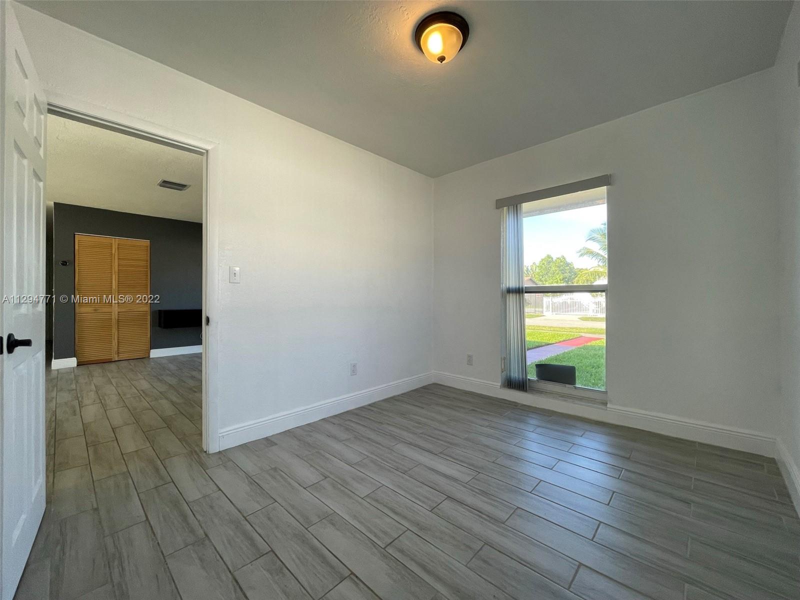 14515 Southwest 105th Court Miami, FL 33176 - Photo 9 of 30 a view of an empty room and window
