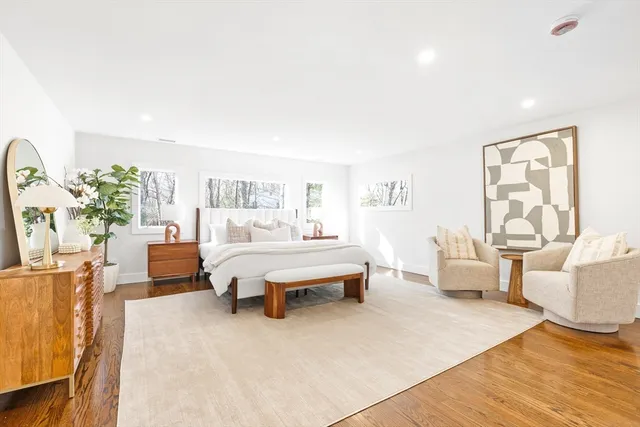 a spacious bedroom with a bed and a couch