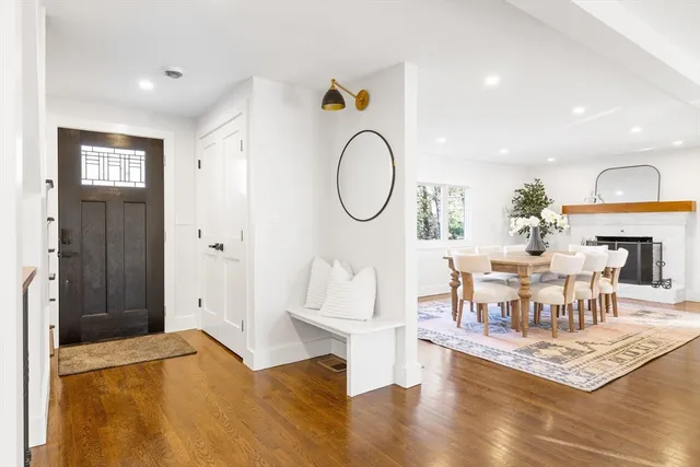 a living room with dining room and wooden floor