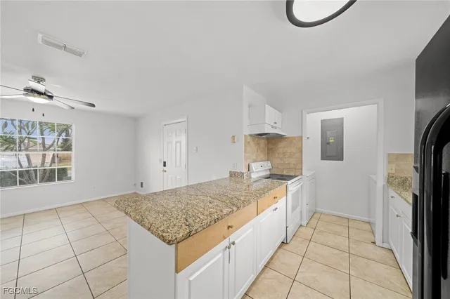 a spacious bathroom with a granite countertop sink a mirror and a shower