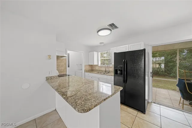 a kitchen with stainless steel appliances granite countertop a refrigerator and a sink