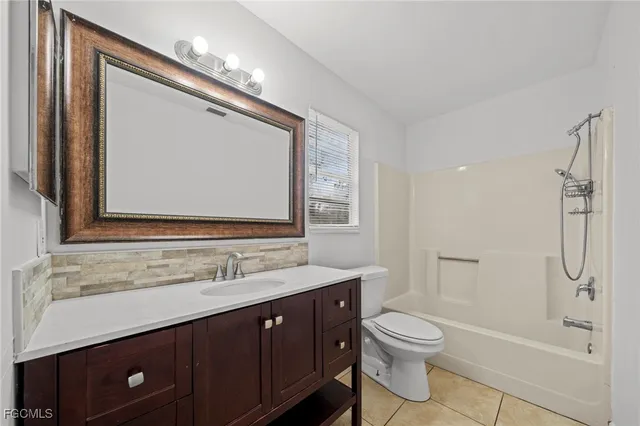 a bathroom with a double vanity sink toilet mirror and bathtub