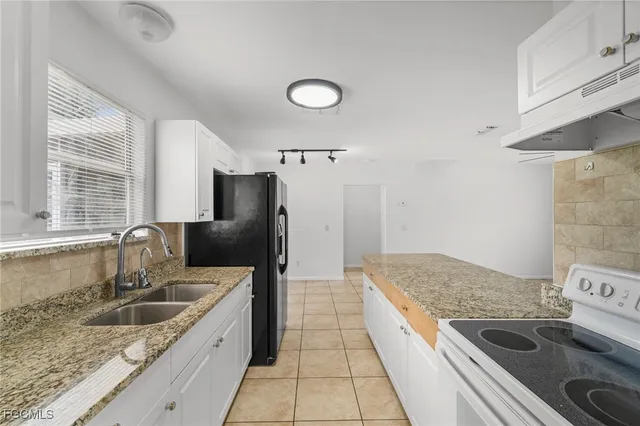 a kitchen with a stove sink and refrigerator