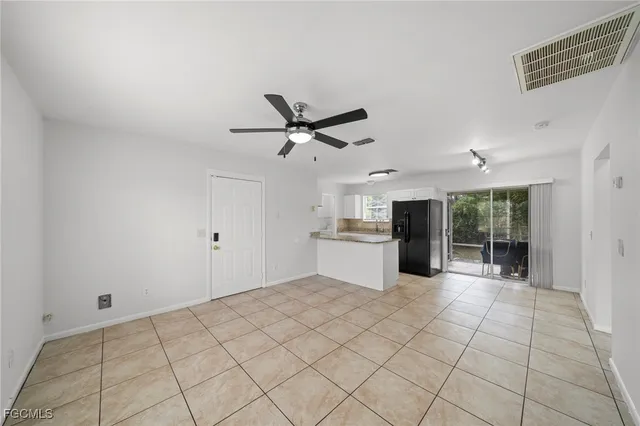 a view of a livingroom with a ceiling fan and window