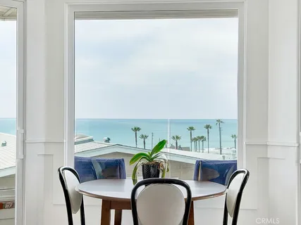 a dining room with furniture and a window
