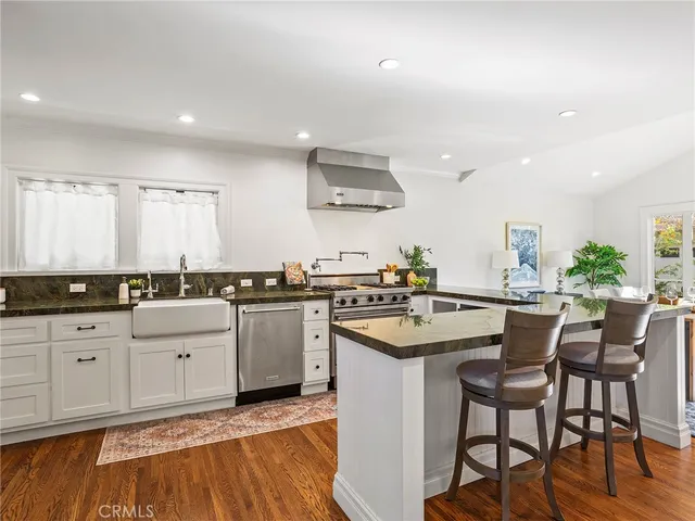 a view of kitchen with cabinets and wooden floor