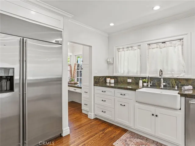 a kitchen with stainless steel appliances granite countertop a sink and cabinets