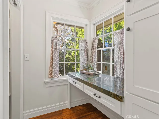 a dining room with furniture a large window and a table