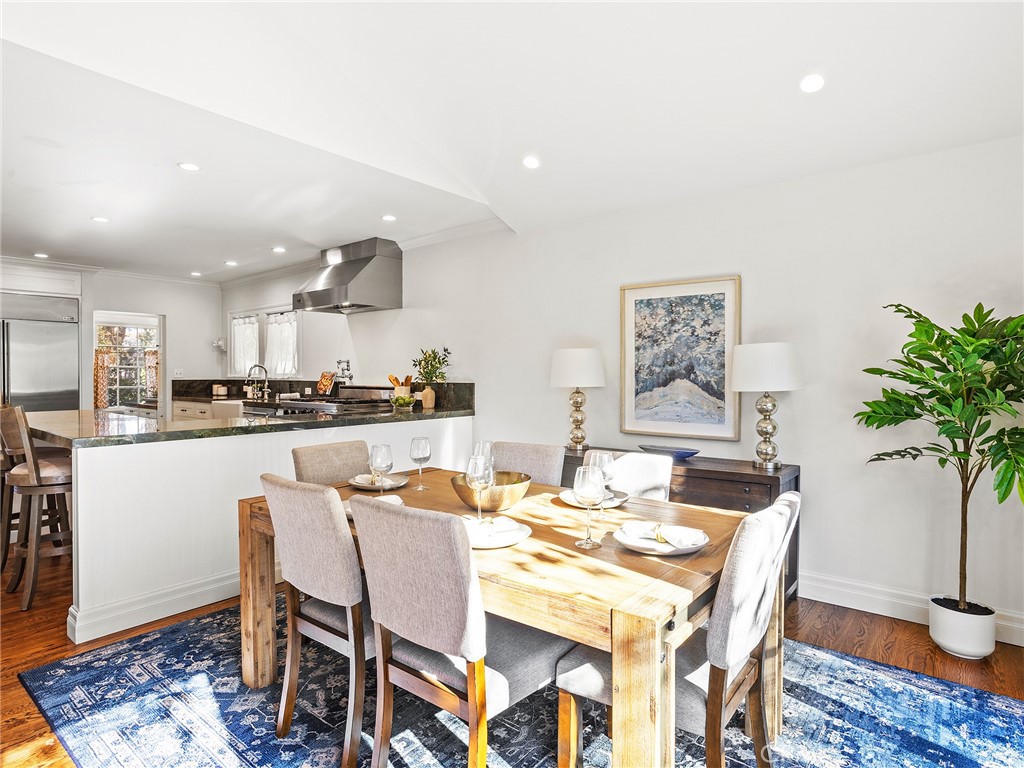 10404 Margate Street North Hollywood, CA 91601 - Photo 20 of 62 a dining room with kitchen island a dining table and chairs