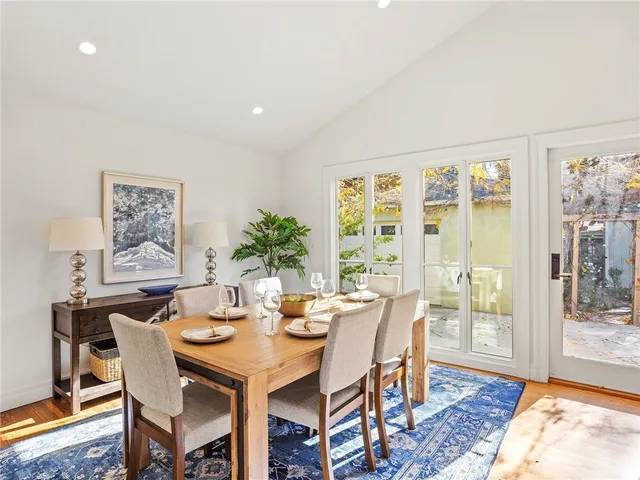 a living room with furniture a fireplace and a large window