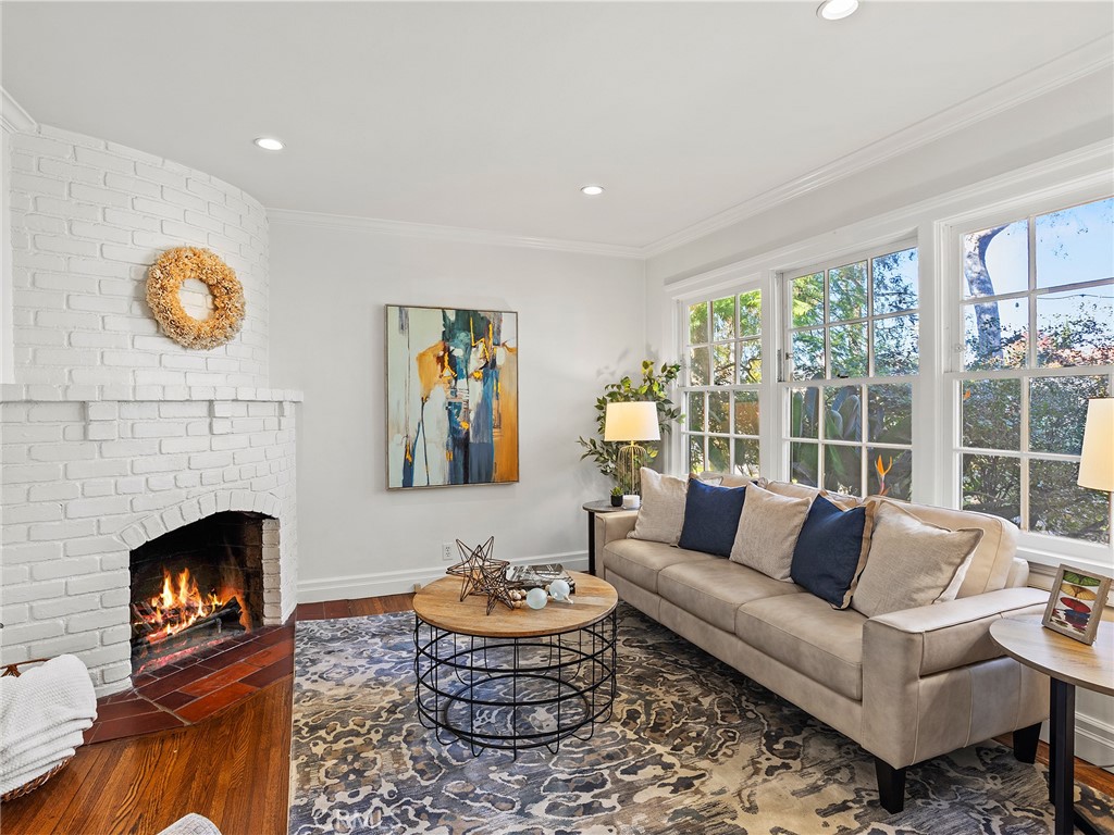 10404 Margate Street North Hollywood, CA 91601 - Photo 27 of 62 a living room with furniture a fireplace and a large window