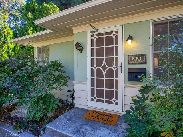 a view of a house with potted plants