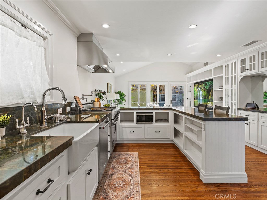 10404 Margate Street North Hollywood, CA 91601 - Photo 8 of 62 a large white kitchen with lots of counter space and sink