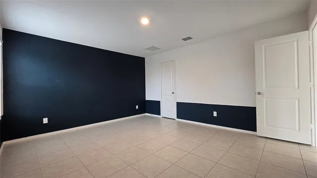 a view of an empty room and a window