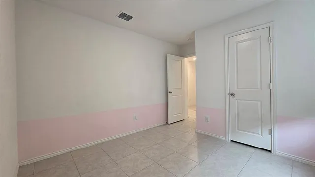 a view of an empty room with windows